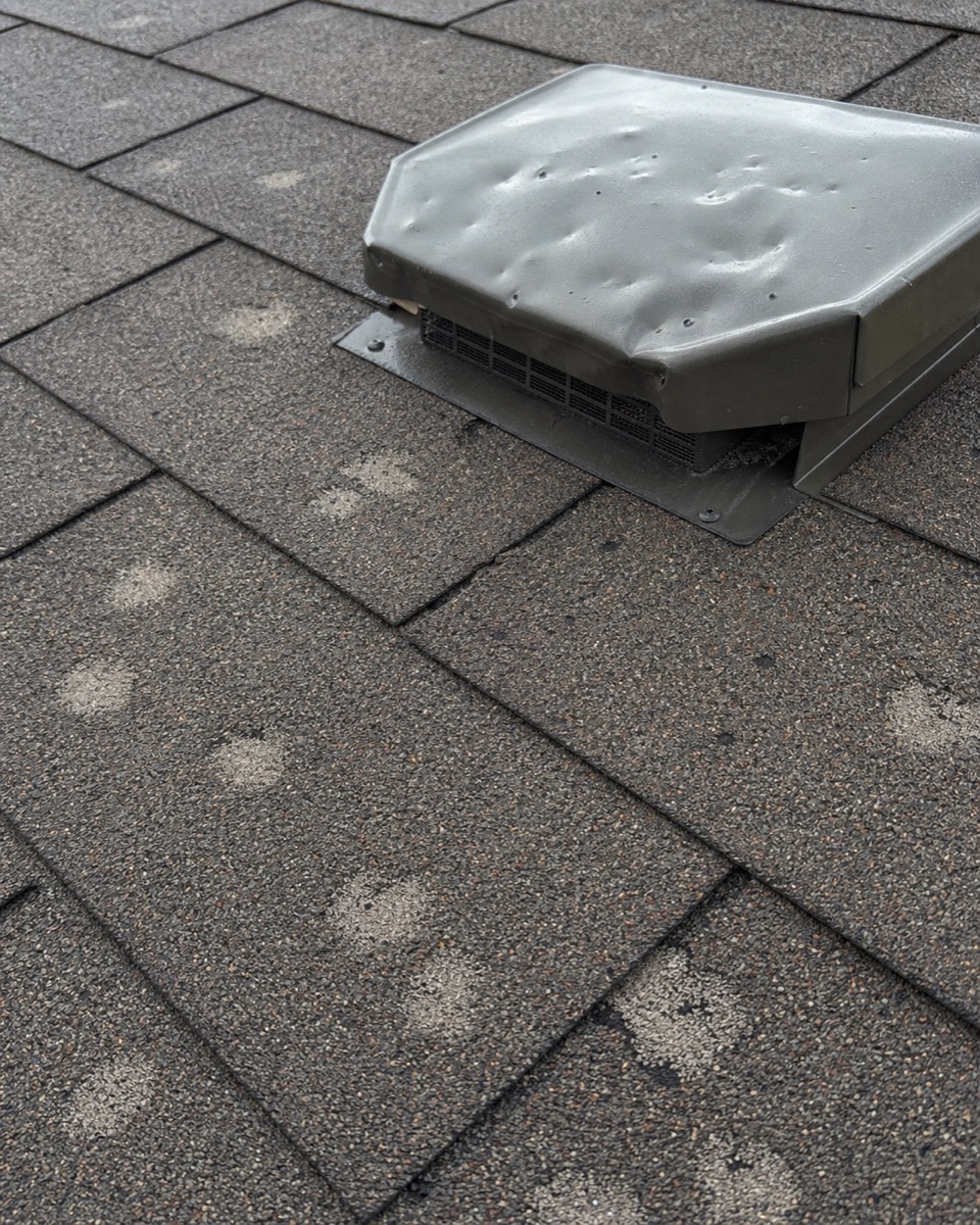 Hail damage marks on a roof surface